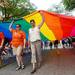 Jim Toy Community Center representatives carry a huge rainbow flag as they march down Main St. during the 23rd Annual Ann Arbor Jaycees Fourth of July Parade on Thursday, July 4, 2013 on South State Street in downtown Ann Arbor. Melanie Maxwell | AnnArbor.com